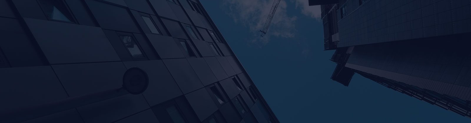 A building with a crane in the background.