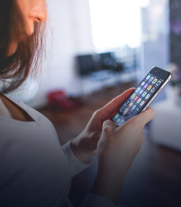 A woman is looking at her phone
