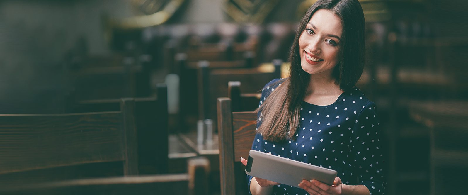 A woman holding an ipad in her hands.