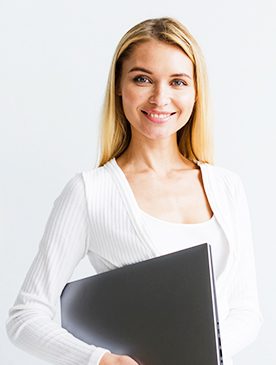 A woman holding a laptop in her hand.