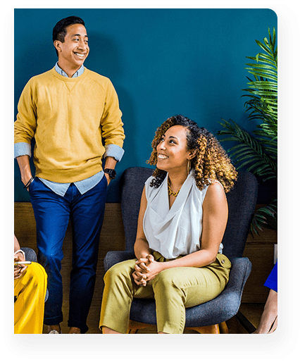 A group of people sitting in chairs and talking.