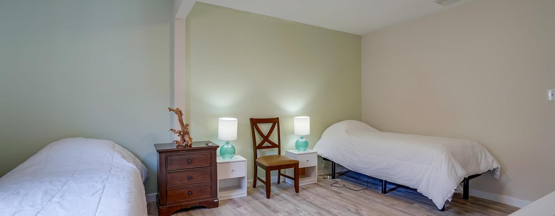 A bedroom with two lamps and a bed