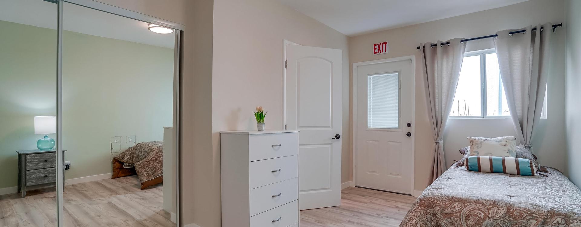 A room with white walls and wooden floors.