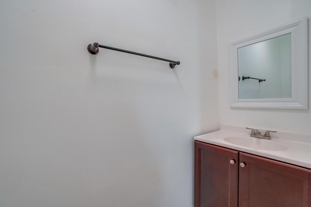 A bathroom with a sink and mirror in it