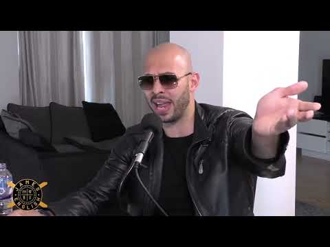 Man gesturing while speaking into a microphone.