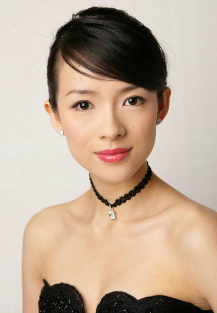 Woman in elegant black dress and choker.