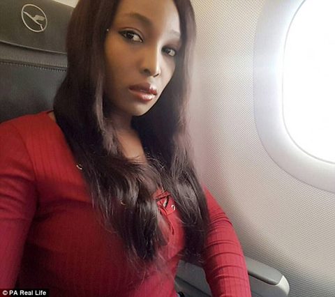 Woman in a red top on an airplane.