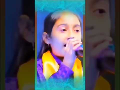 Young girl singing into a microphone.